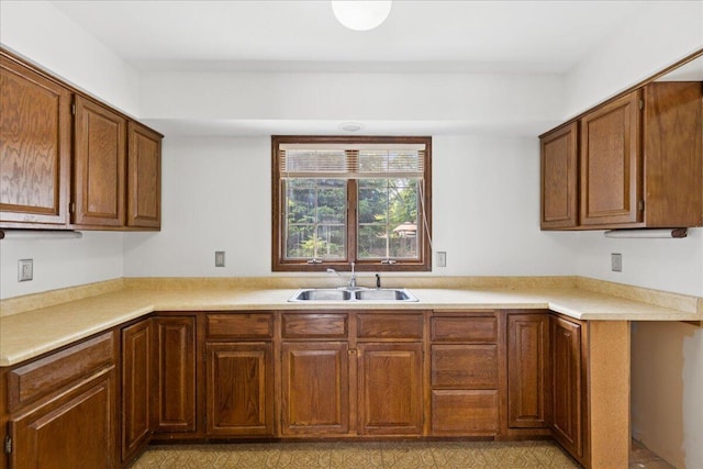 685 Hawthorne Dr, Circleville, OH 43113 - kitchen with a sink, brown cabinetry, and light countertops
