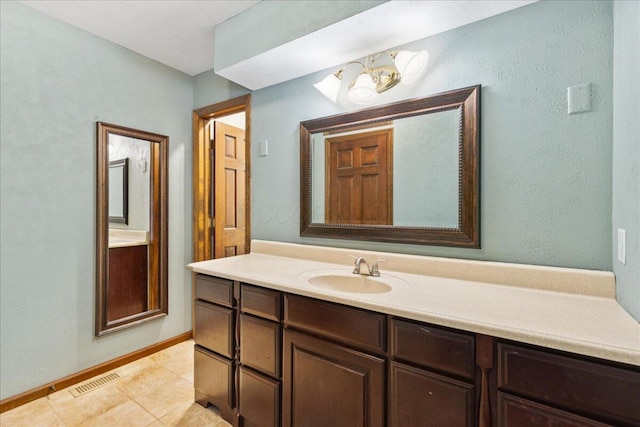 685 Hawthorne Dr, Circleville, OH 43113 - bathroom featuring vanity, a chandelier, tile patterned flooring, and baseboards