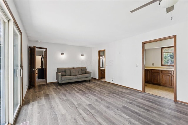 685 Hawthorne Dr, Circleville, OH 43113 - living room with light wood finished floors, a ceiling fan, and baseboards