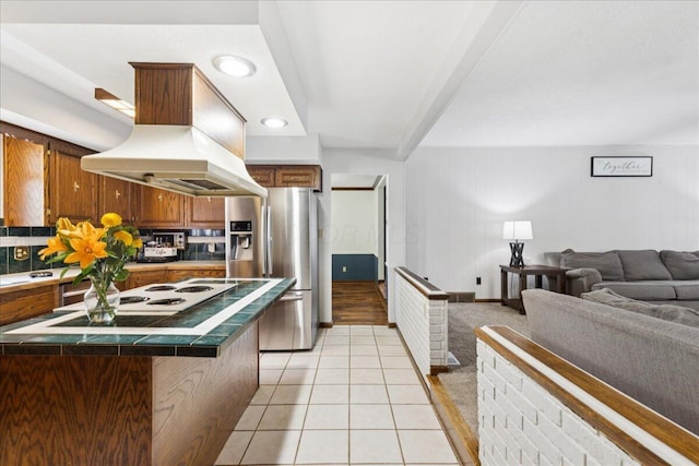 685 Hawthorne Dr, Circleville, OH 43113 - kitchen featuring custom range hood, stainless steel fridge with ice dispenser, tile counters, light tile patterned flooring, and open floor plan