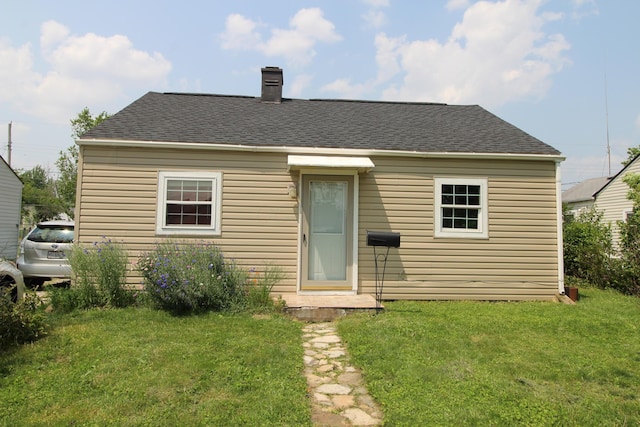 3136 E 12th Ave, Columbus, OH 43219 - rear view of house with a lawn, a chimney, and a shingled roof