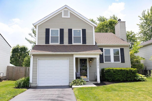 1771 Redcloud Dr, Powell, OH 43065 - view of front facade featuring an attached garage, asphalt driveway, a chimney, and roof with shingles