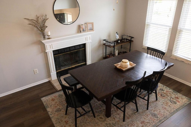 1771 Redcloud Dr, Powell, OH 43065 - dining area with wood finished floors, baseboards, and a glass covered fireplace