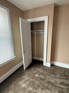 863 E Whittier St, Columbus, OH 43206 - unfurnished bedroom featuring baseboards, a closet, and carpet
