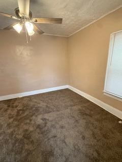 863 E Whittier St, Columbus, OH 43206 - empty room with ceiling fan, dark colored carpet, and baseboards