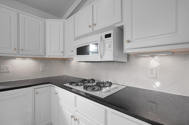 1263 Clubview Blvd S, Columbus, OH 43235 - kitchen with white appliances, dark countertops, white cabinetry, decorative backsplash, and vaulted ceiling