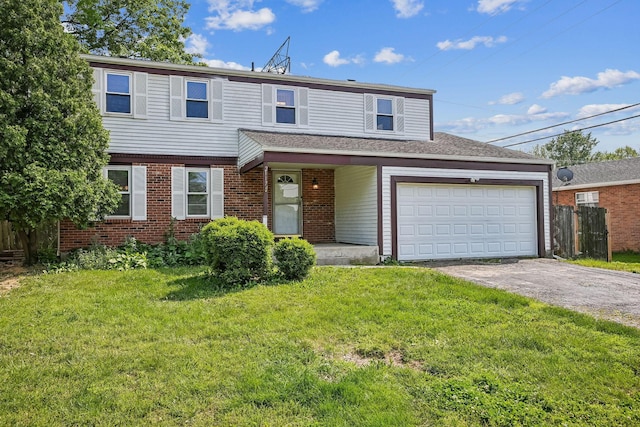 2117 Kilbourne Ave, Columbus, OH 43229 - view of front of house with driveway, a garage, and brick siding
