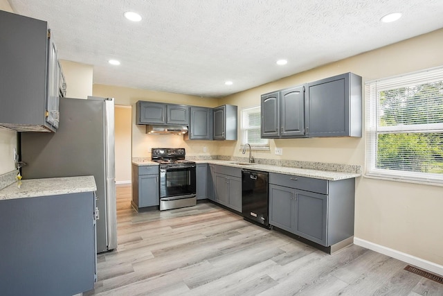 2117 Kilbourne Ave, Columbus, OH 43229 - kitchen with range with electric stovetop, black dishwasher, under cabinet range hood, gray cabinets, and a sink