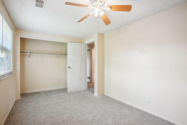 2117 Kilbourne Ave, Columbus, OH 43229 - unfurnished bedroom with carpet floors, a closet, a textured ceiling, baseboards, and a ceiling fan