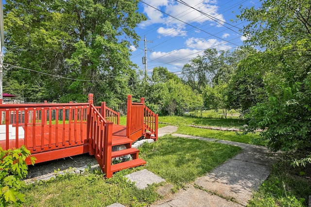 2117 Kilbourne Ave, Columbus, OH 43229 - view of grassy yard featuring a wooden deck and view of wooded area