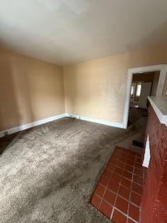 865 E Whittier St, Columbus, OH 43206 - unfurnished living room featuring carpet flooring and baseboards