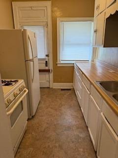 865 E Whittier St, Columbus, OH 43206 - kitchen with white range with gas cooktop and white cabinetry