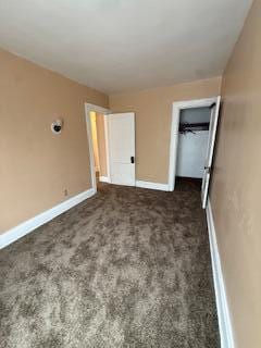 865 E Whittier St, Columbus, OH 43206 - unfurnished bedroom featuring dark carpet and baseboards