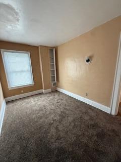 865 E Whittier St, Columbus, OH 43206 - unfurnished bedroom featuring baseboards and carpet flooring