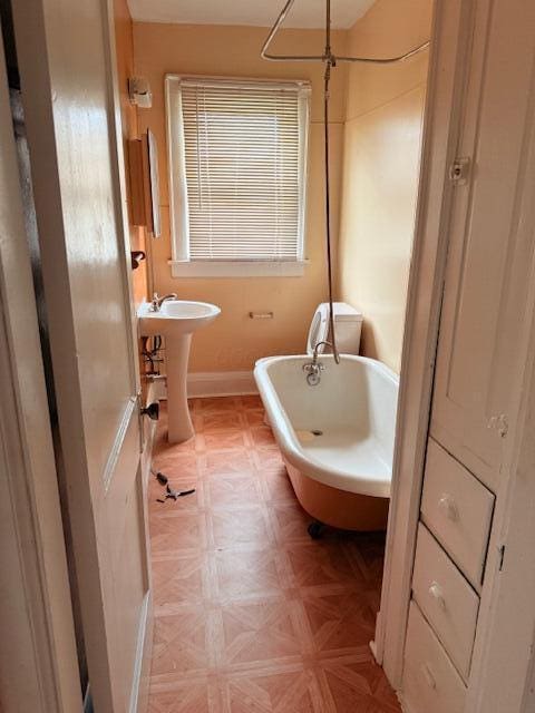 869 E Whittier St, Columbus, OH 43206 - bathroom with a freestanding tub and baseboards