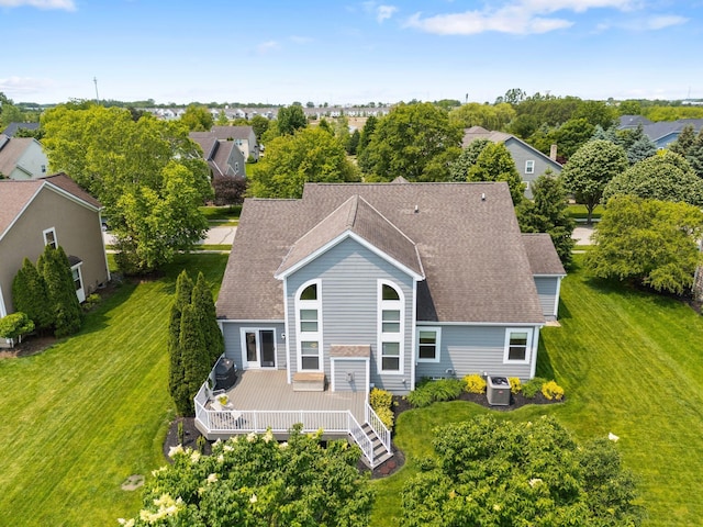 7494 Barrister Dr, Dublin, OH 43016 - view of front facade with roof with shingles, a deck, a front lawn, and view of wooded area