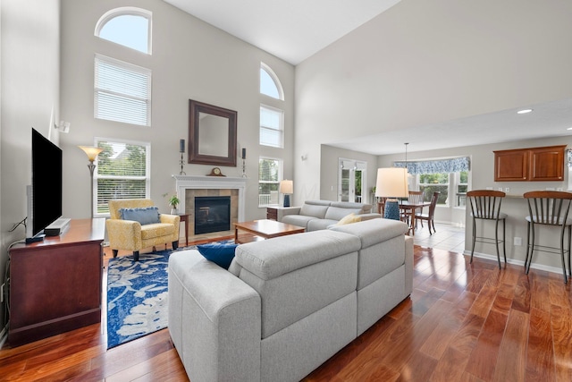 7494 Barrister Dr, Dublin, OH 43016 - living area featuring a towering ceiling, dark wood-type flooring, a fireplace, baseboards, and recessed lighting