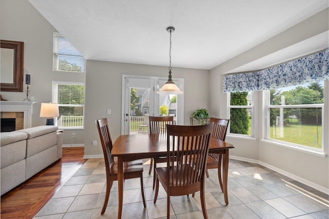 7494 Barrister Dr, Dublin, OH 43016 - dining space with healthy amount of natural light, light tile patterned floors, baseboards, and a tile fireplace
