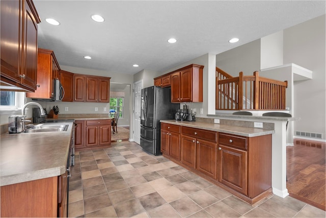 7494 Barrister Dr, Dublin, OH 43016 - kitchen with a sink, freestanding refrigerator, baseboards, recessed lighting, and light countertops