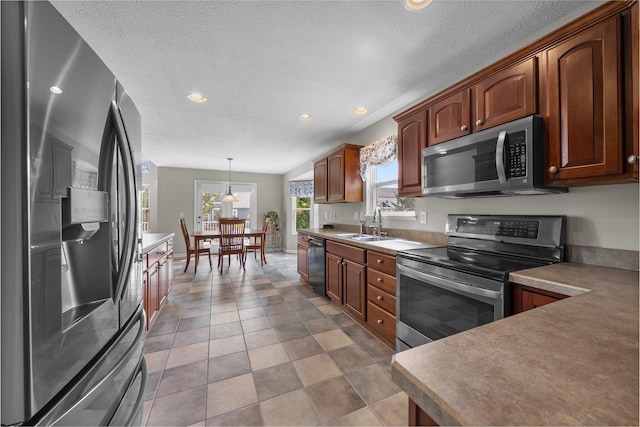 7494 Barrister Dr, Dublin, OH 43016 - kitchen featuring stainless steel appliances, recessed lighting, a sink, plenty of natural light, and hanging light fixtures