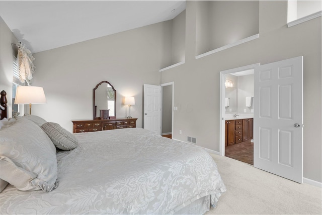 7494 Barrister Dr, Dublin, OH 43016 - carpeted bedroom with a towering ceiling, ensuite bath, and baseboards
