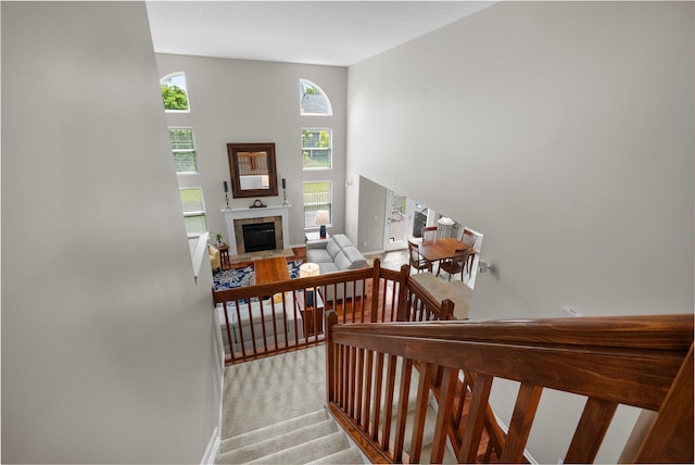 7494 Barrister Dr, Dublin, OH 43016 - stairway featuring a tile fireplace, carpet floors, and baseboards