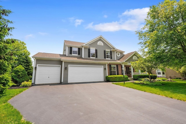 7494 Barrister Dr, Dublin, OH 43016 - view of front of home with asphalt driveway, a front yard, and an attached garage