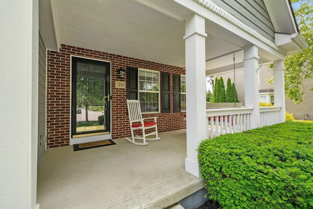7494 Barrister Dr, Dublin, OH 43016 - doorway to property featuring covered porch and brick siding
