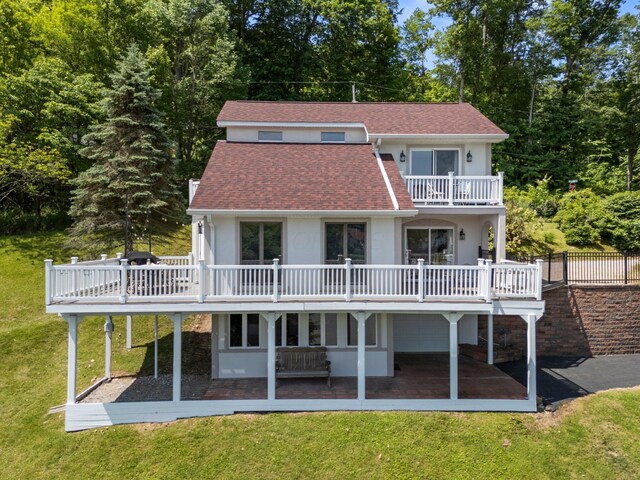 14 Wells Jones Rd, Waverly, OH 45690 - back of property featuring stucco siding, a patio, a balcony, roof with shingles, and a yard