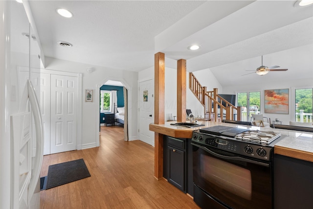 14 Wells Jones Rd, Waverly, OH 45690 - kitchen featuring black stove, white fridge with ice dispenser, a ceiling fan, light countertops, and light wood finished floors