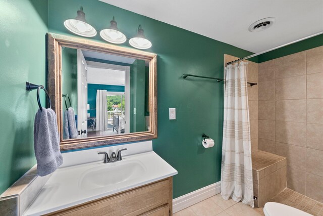 14 Wells Jones Rd, Waverly, OH 45690 - full bathroom featuring vanity, a tile shower, baseboards, and tile patterned flooring