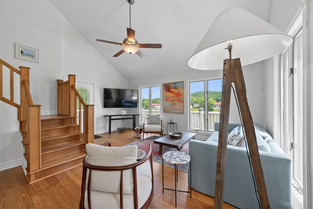 14 Wells Jones Rd, Waverly, OH 45690 - living room with high vaulted ceiling, stairs, wood finished floors, ceiling fan, and baseboards