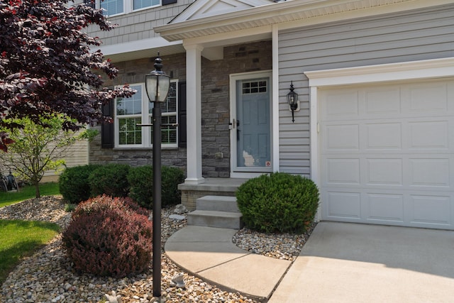 676 Ferguson Ave, Delaware, OH 43015 - property entrance featuring stone siding, a porch, and a garage