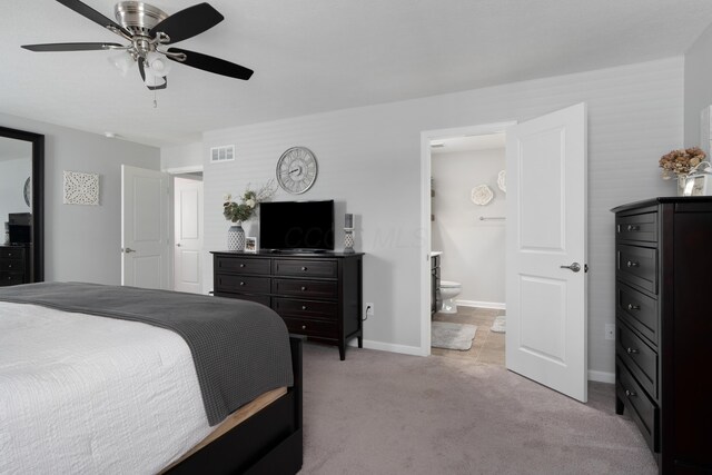 676 Ferguson Ave, Delaware, OH 43015 - bedroom with light colored carpet, baseboards, ensuite bathroom, and a ceiling fan