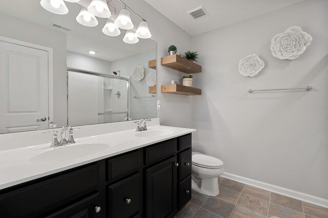 676 Ferguson Ave, Delaware, OH 43015 - full bath with double vanity, baseboards, a stall shower, toilet, and a chandelier