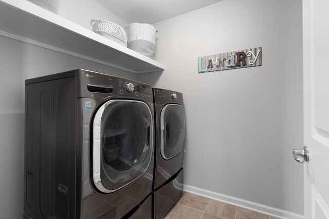676 Ferguson Ave, Delaware, OH 43015 - washroom with washer and dryer and baseboards