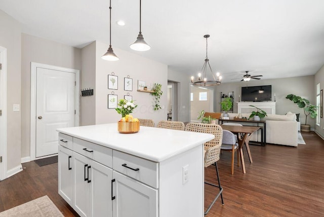 1211 Mcclish Ct, Grove City, OH 43123 - kitchen featuring dark wood-type flooring, a kitchen island, white cabinetry, and decorative light fixtures