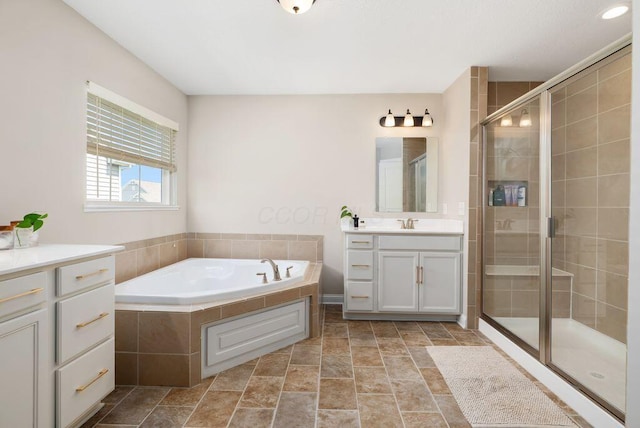 1211 Mcclish Ct, Grove City, OH 43123 - bathroom featuring vanity, a bath, a stall shower, and stone finish flooring