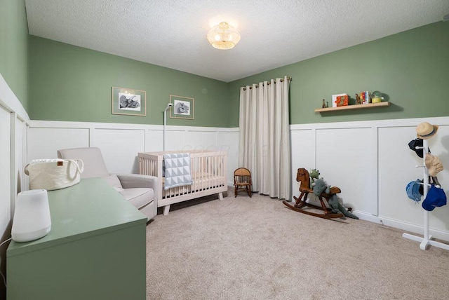 1211 Mcclish Ct, Grove City, OH 43123 - carpeted bedroom with a nursery area, a wainscoted wall, a decorative wall, and a textured ceiling