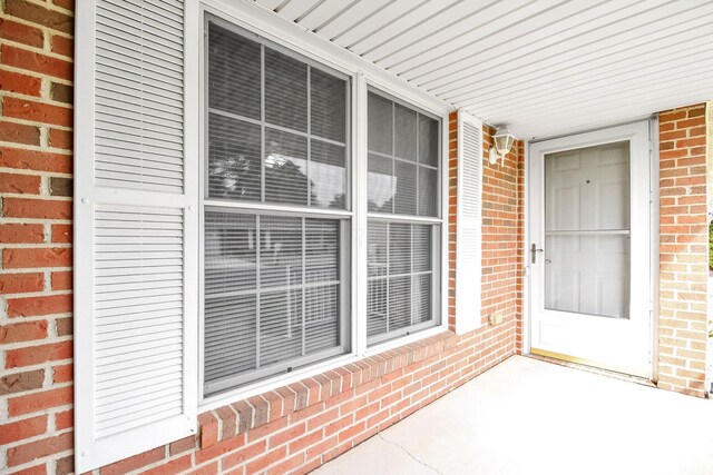 106 Kings Way W, Jefferson, OH 43162 - doorway to property featuring brick siding and a porch