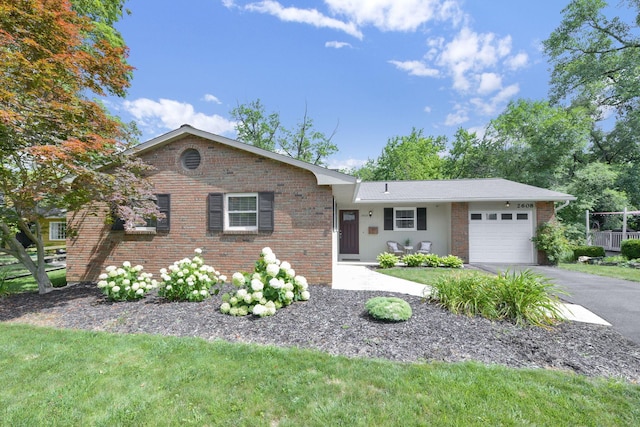 2608 Edgevale Rd, Columbus, OH 43221 - ranch-style home featuring an attached garage, driveway, and brick siding