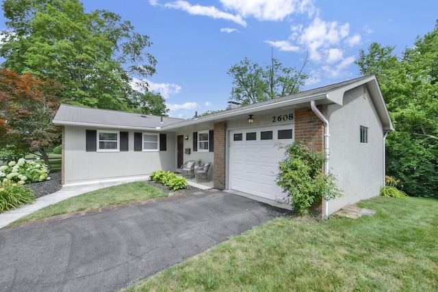 2608 Edgevale Rd, Columbus, OH 43221 - ranch-style house featuring an attached garage, driveway, and a front lawn