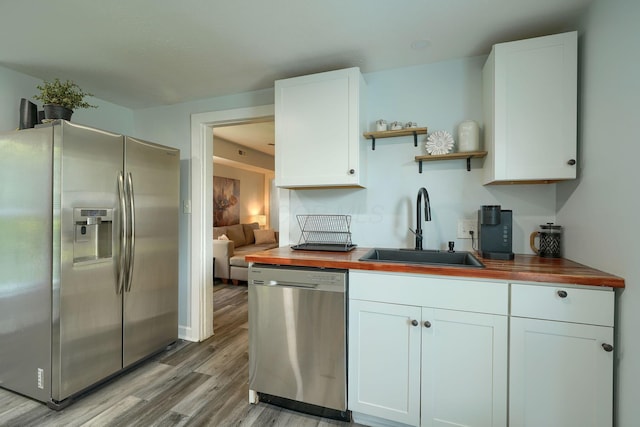 202 Boyleston Ave, Newark, OH 43055 - kitchen with appliances with stainless steel finishes, a sink, wooden counters, light wood finished floors, and open shelves