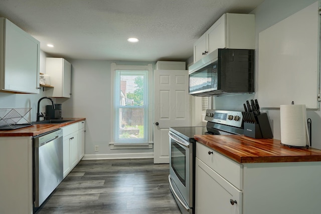 202 Boyleston Ave, Newark, OH 43055 - kitchen featuring butcher block counters, stainless steel appliances, a sink, dark wood-style flooring, and recessed lighting