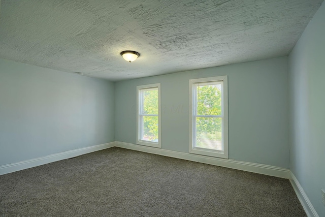 202 Boyleston Ave, Newark, OH 43055 - unfurnished room with dark carpet, baseboards, and a textured ceiling