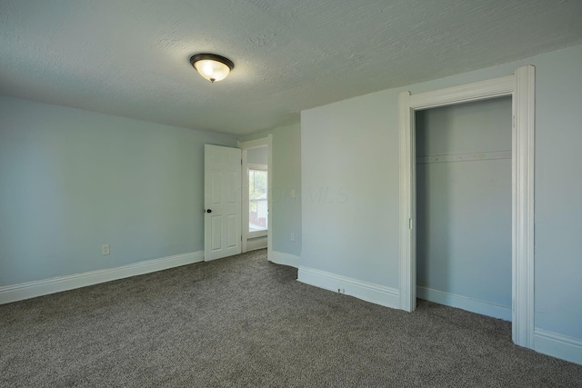 202 Boyleston Ave, Newark, OH 43055 - unfurnished bedroom with dark carpet, a closet, baseboards, and a textured ceiling