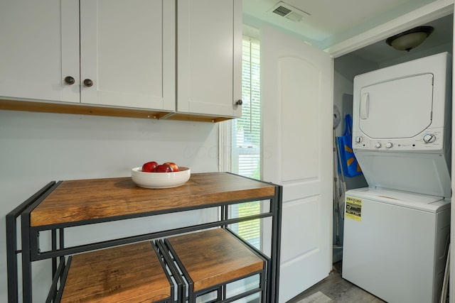 202 Boyleston Ave, Newark, OH 43055 - laundry room with stacked washer / dryer, plenty of natural light, and light wood-style floors