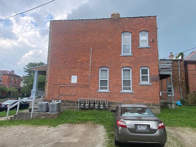 337 Tappan St, Columbus, OH 43201 - view of side of property with brick siding and central air condition unit