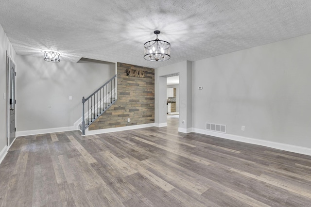 1137 Hoover Lake Ct, Westerville, OH 43081 - unfurnished living room featuring a chandelier, stairway, wood finished floors, a textured ceiling, and baseboards