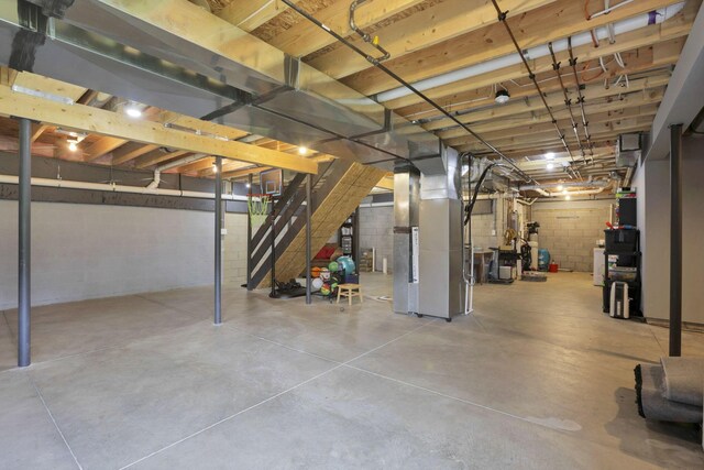 9559 Basil Rd NW, Baltimore, OH 43105 - unfinished basement with heating unit, stairs, and concrete block wall